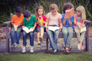 43914407 - children reading from books together while sitting down