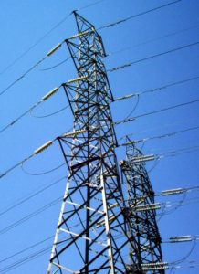 Electrical grid – pylons and cables distribute power. Released to Public Domain by its author, ShiftChange.
