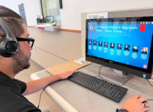 Bailiff Bulmaro Ramirez demonstrates use of the justice station at the Gallup Magistrate Court.
